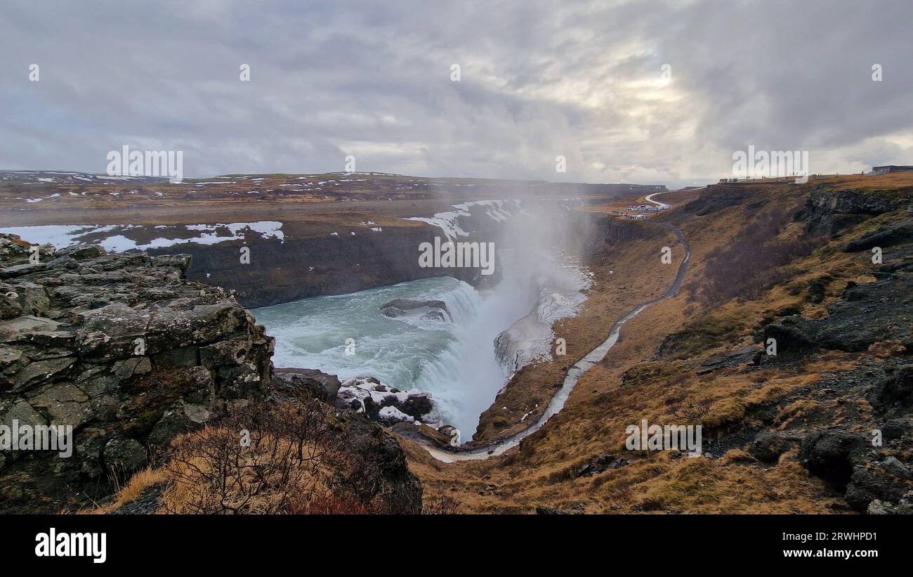 Spectacular Gullfoss waterfall in icelandic region, majestic river flow pouring down frosty hilltop edges. Nordic nature presents cascade running off cliffs in iceland, water stream. Stock Photo