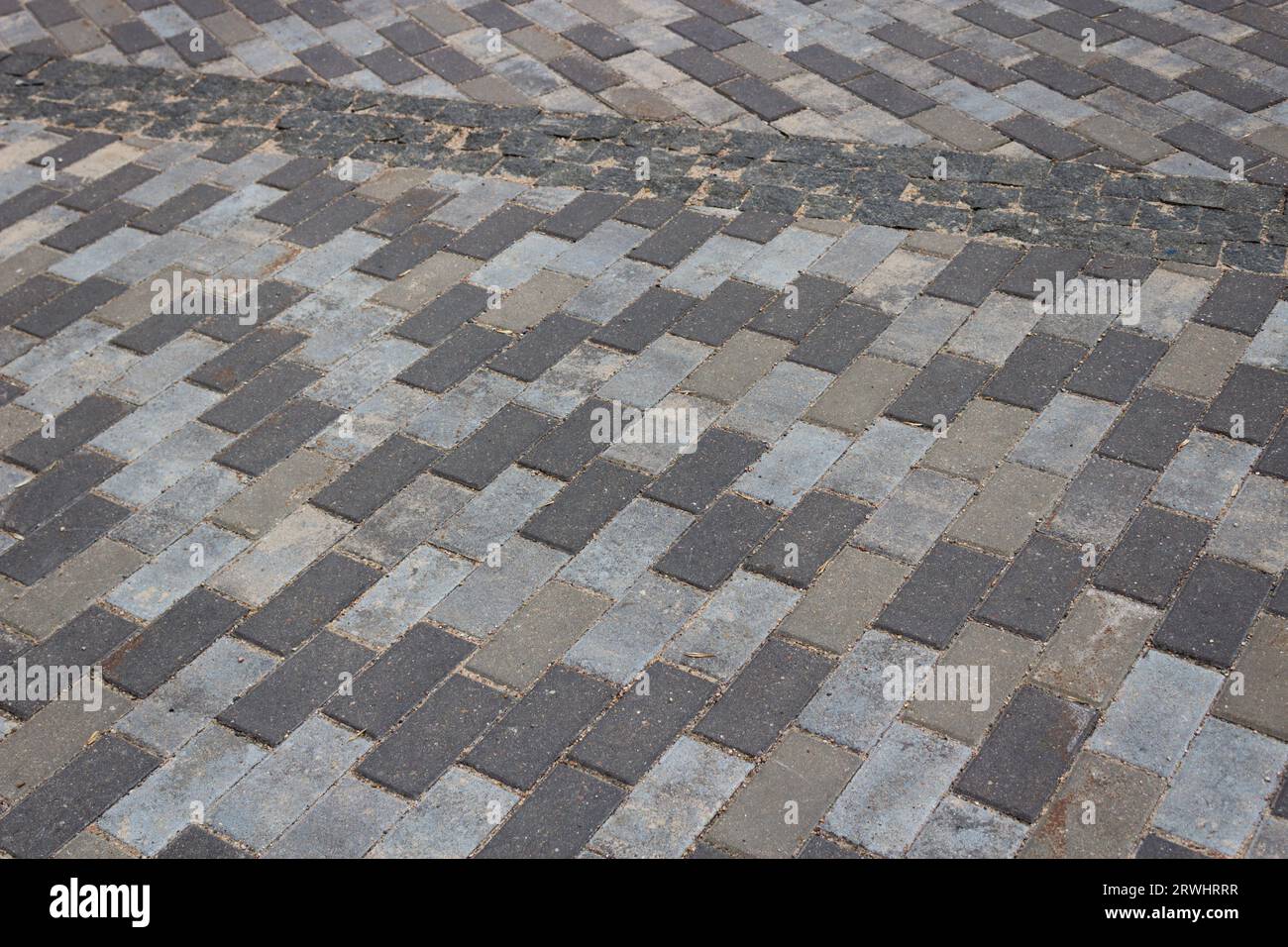Background in the form of motley gray concrete tiles of a rectangular shape. Stock Photo