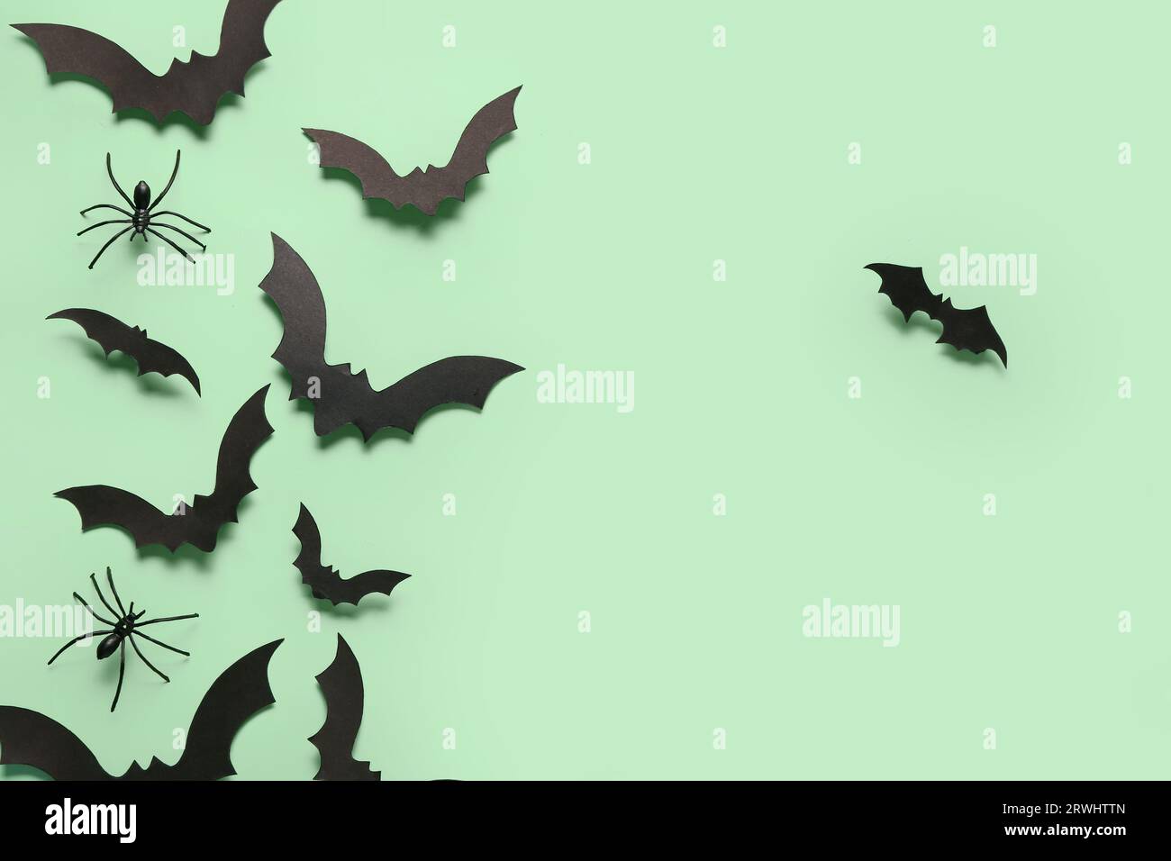 Paper bats and spiders for Halloween party on green background Stock ...