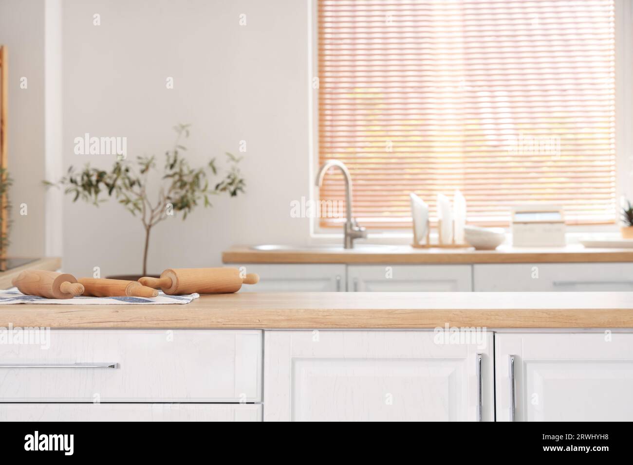 Interior of light kitchen with white counters and sink Stock Photo - Alamy