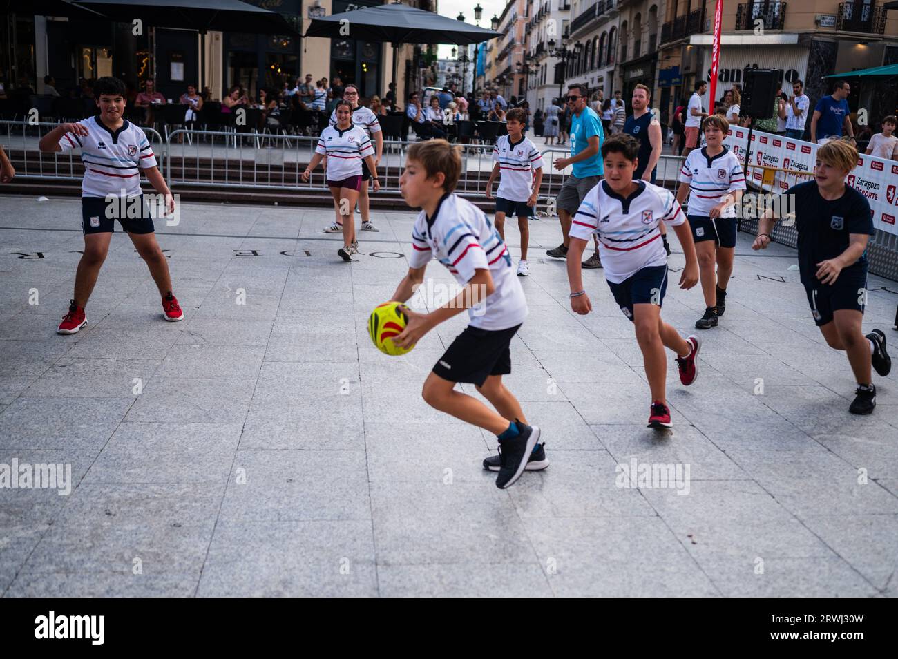 Kids trying rugby during Sports Day multi-sports street event in Plaza del Pilar, Zaragoza, Spain Stock Photo