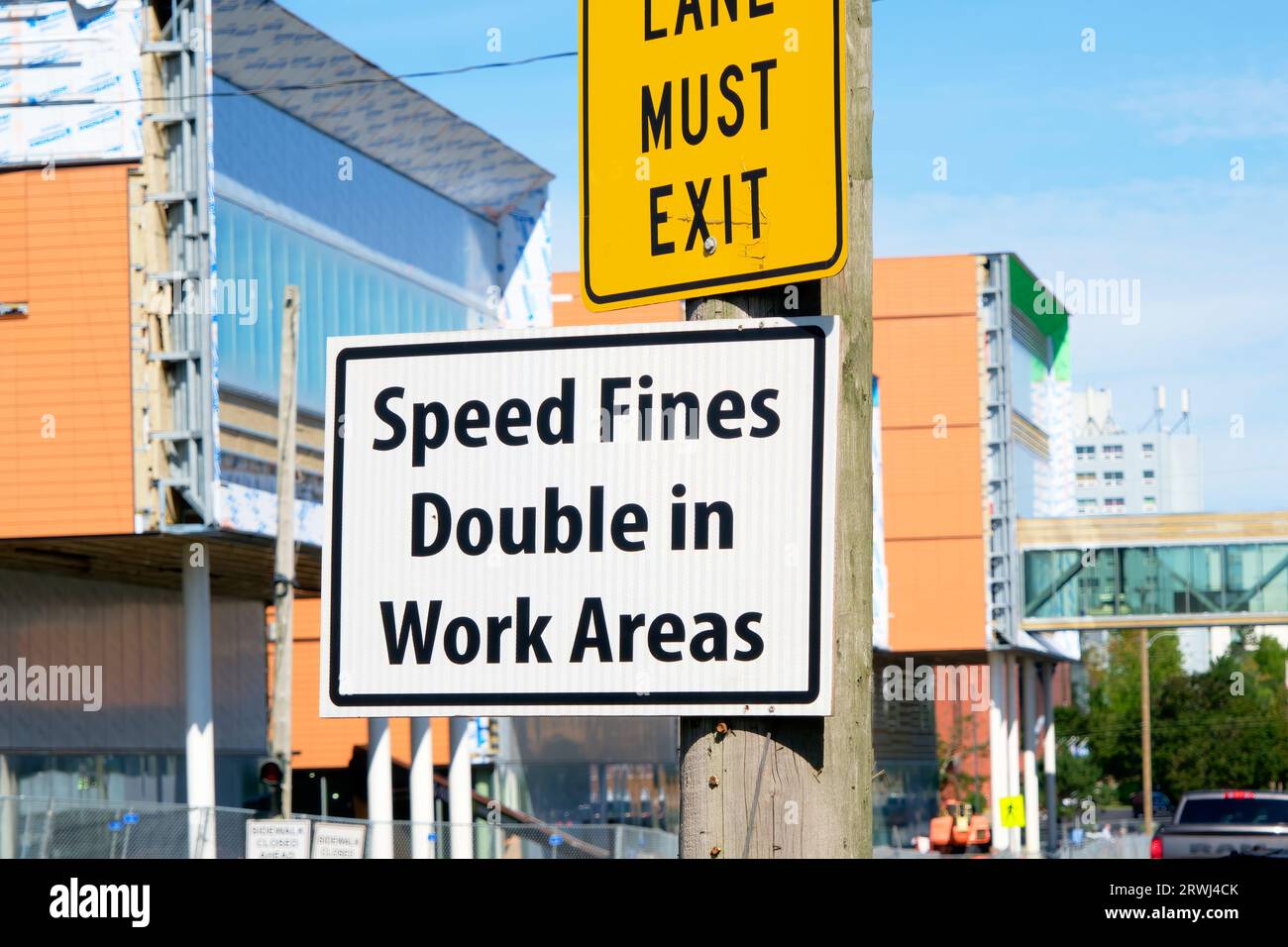 Sign in a construction zone warning that fines for speeding will be