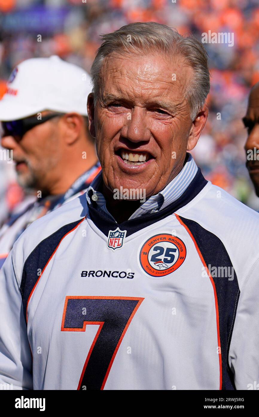 Former Denver Broncos quarterback John Elway looks on during a