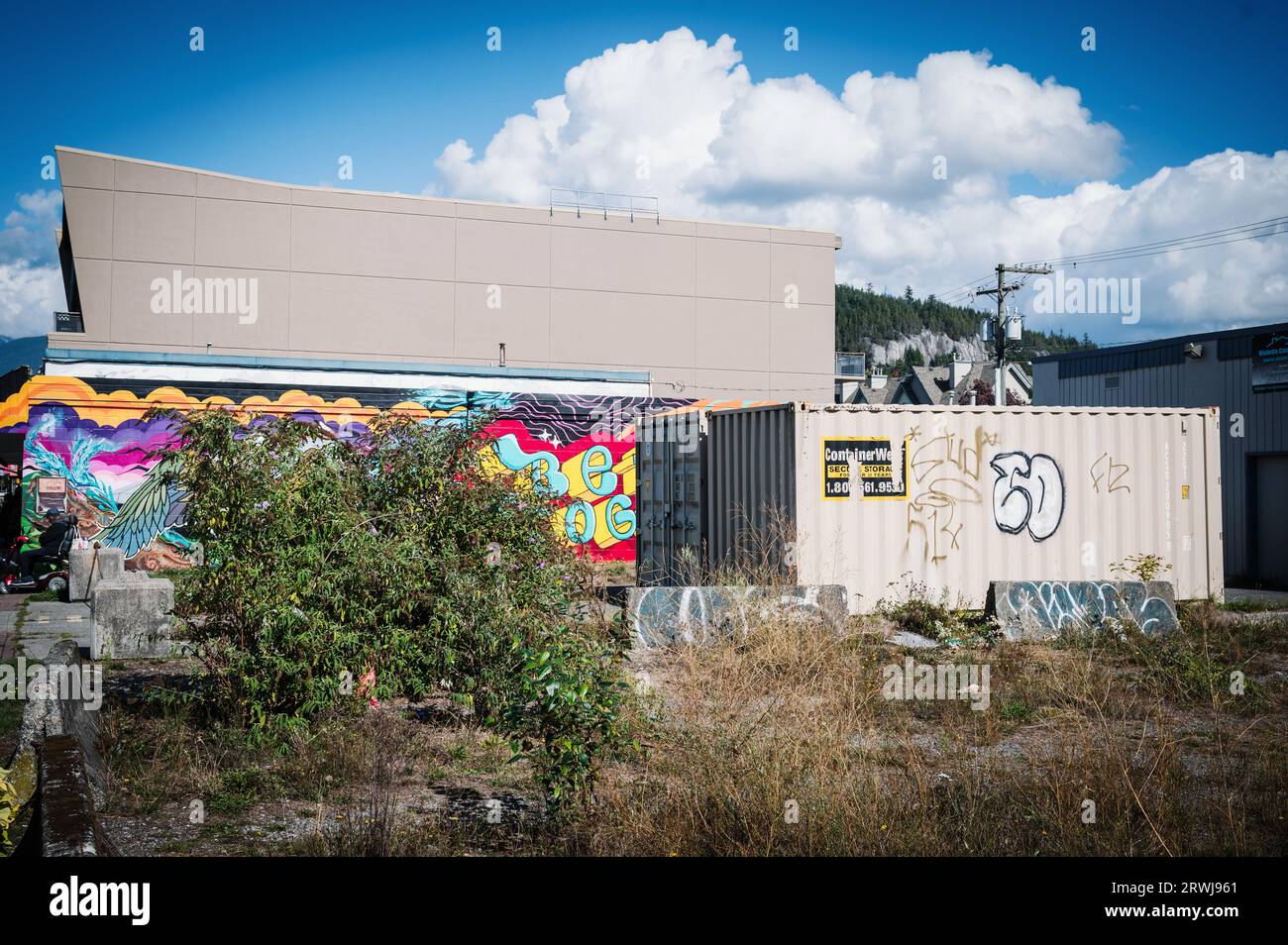 An empty lot with an old steel shipping container.  Squamish BC, Canada. Stock Photo