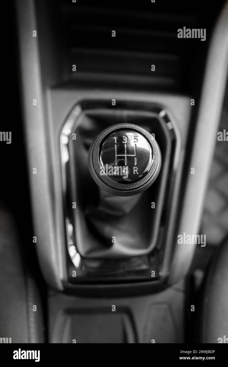 Detailed shot of a 5-speed manual transmission gear stick, showcasing its design and markings. Stock Photo