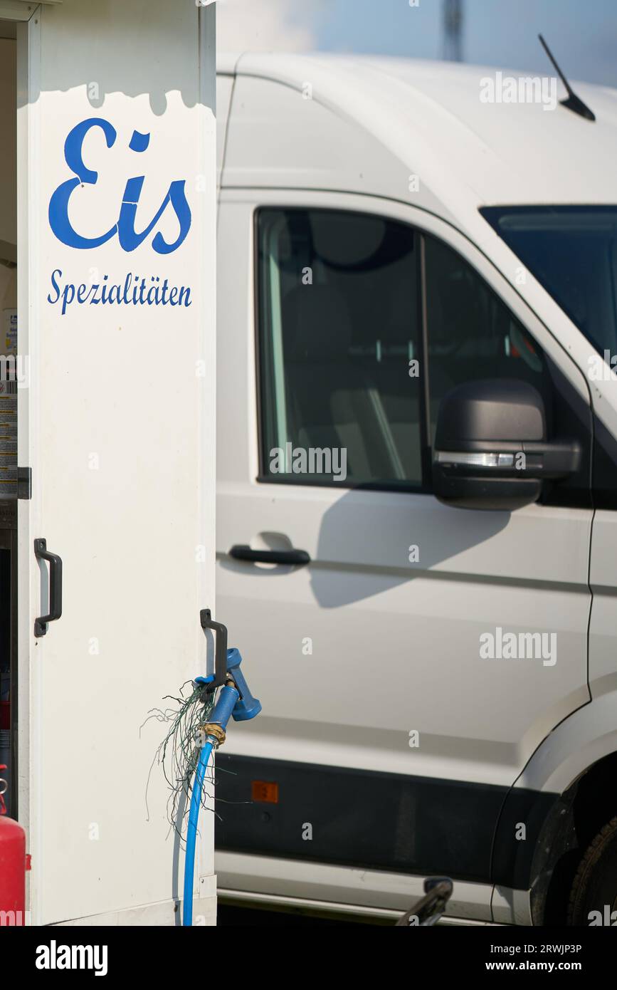 Ice cream truck for selling ice cream at a folk festival in summer in Germany. Translation ice