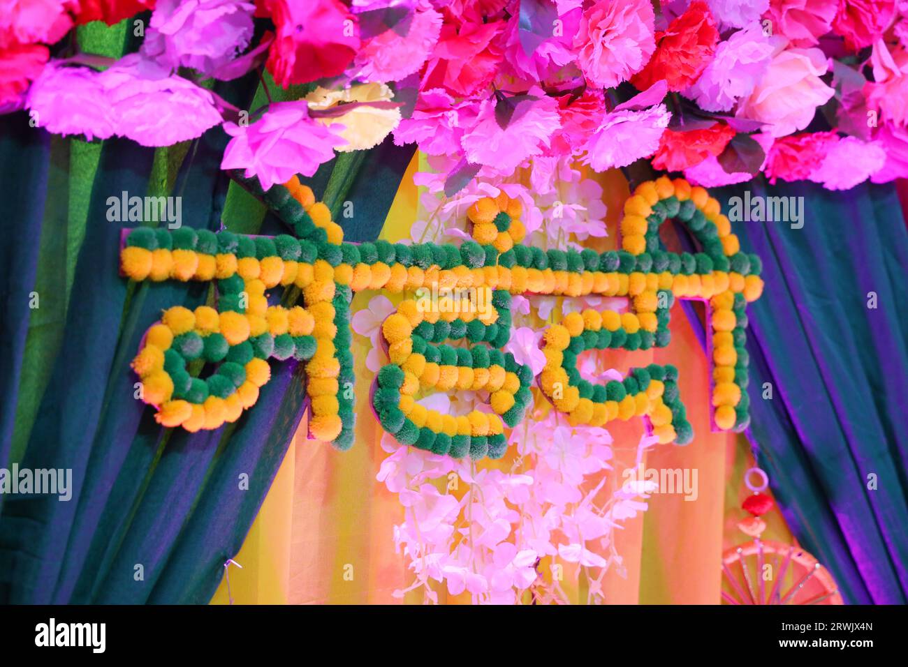 Mehndi hindi text with decorative flowers at mehendi function in india