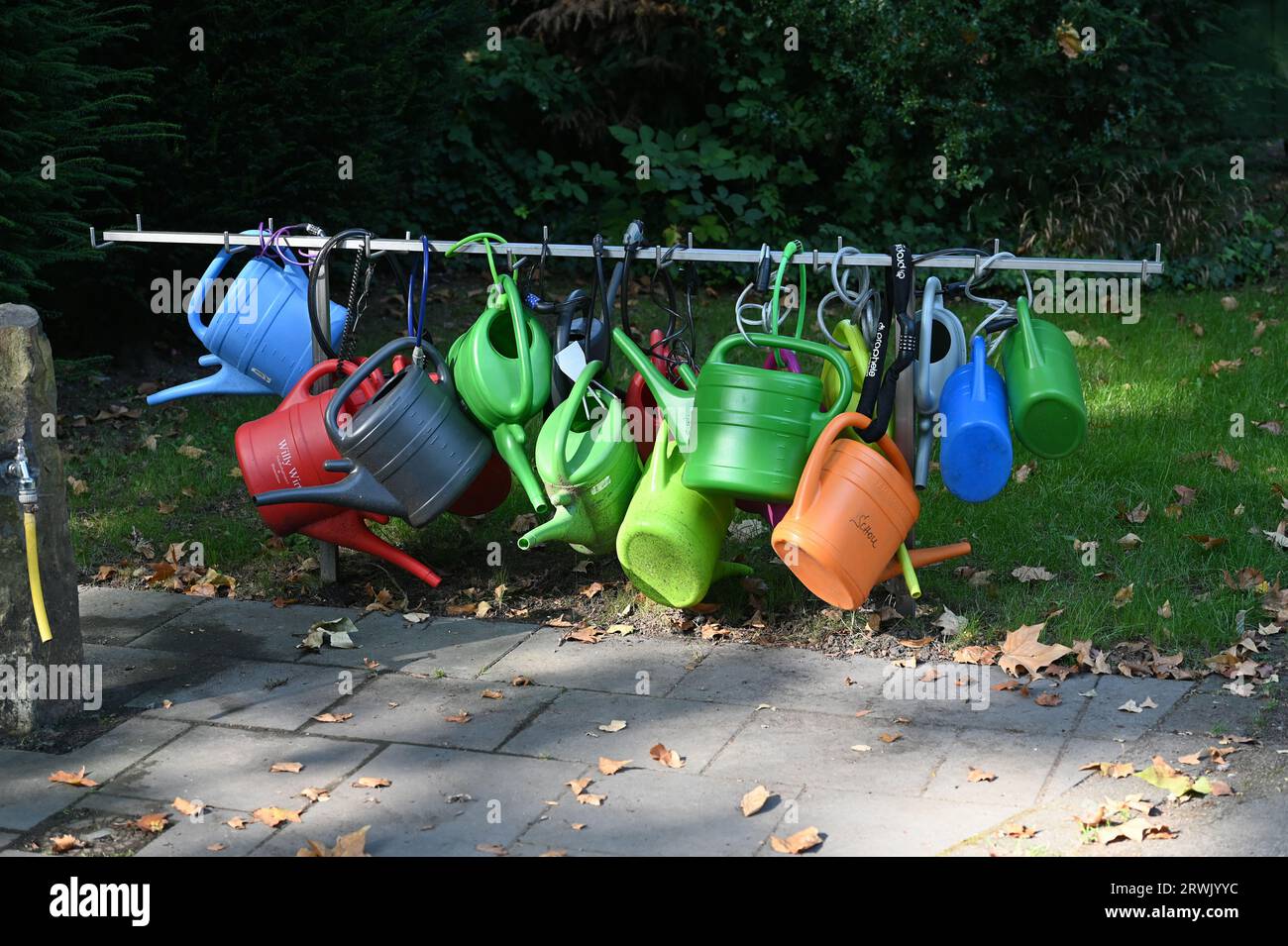 Cologne, Germany. 10th Sep, 2023. Here hang watering cans that can be borrowed for a fee at the Cologne celebrity cemetery Melaten Credit: Horst Galuschka/dpa/Horst Galuschka dpa/Alamy Live News Stock Photo