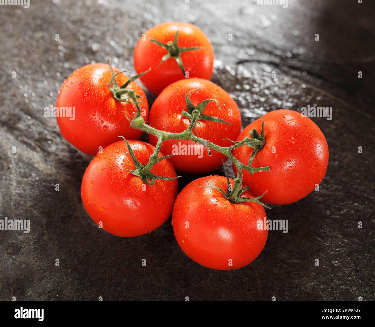Ripe red tomatoes on stone Stock Photo