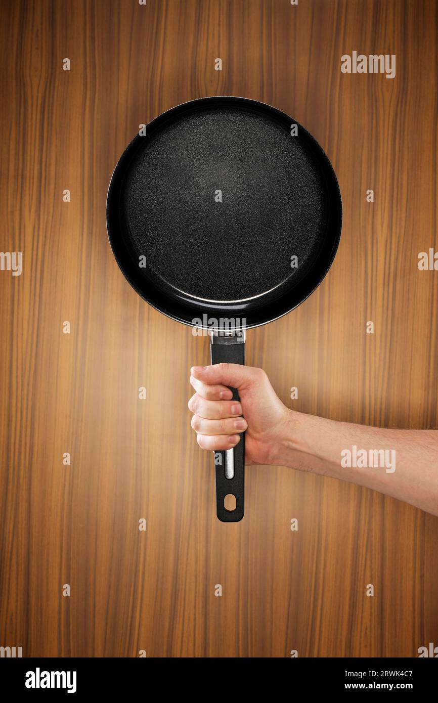 Man holding a saucepan which has a ceramic non-stick coating Stock Photo