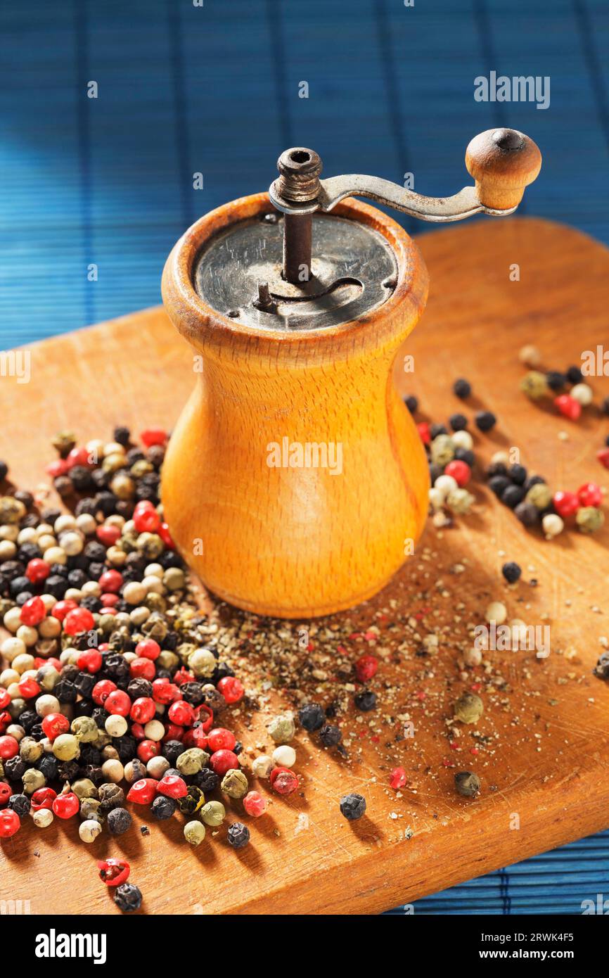 Old Pepper grinder mill with different dried peppers Stock Photo Alamy