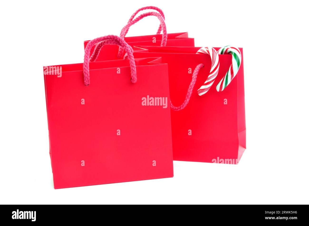 Three red bags with candy canes and text space Stock Photo Alamy