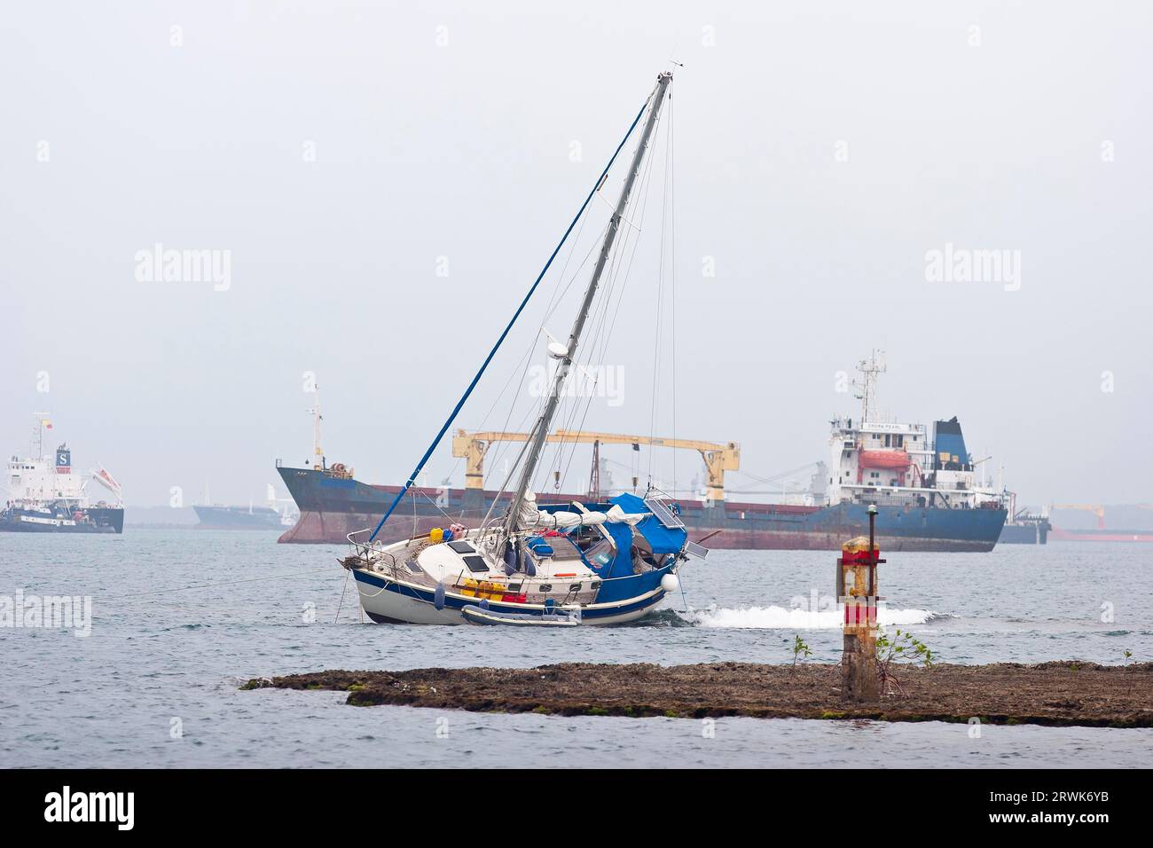 Stranded sailing yacht at the entrance to the Panama Canal Stock Photo