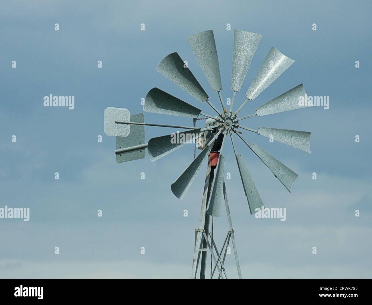 Metal wind direction indicator, background blue sky Stock Photo