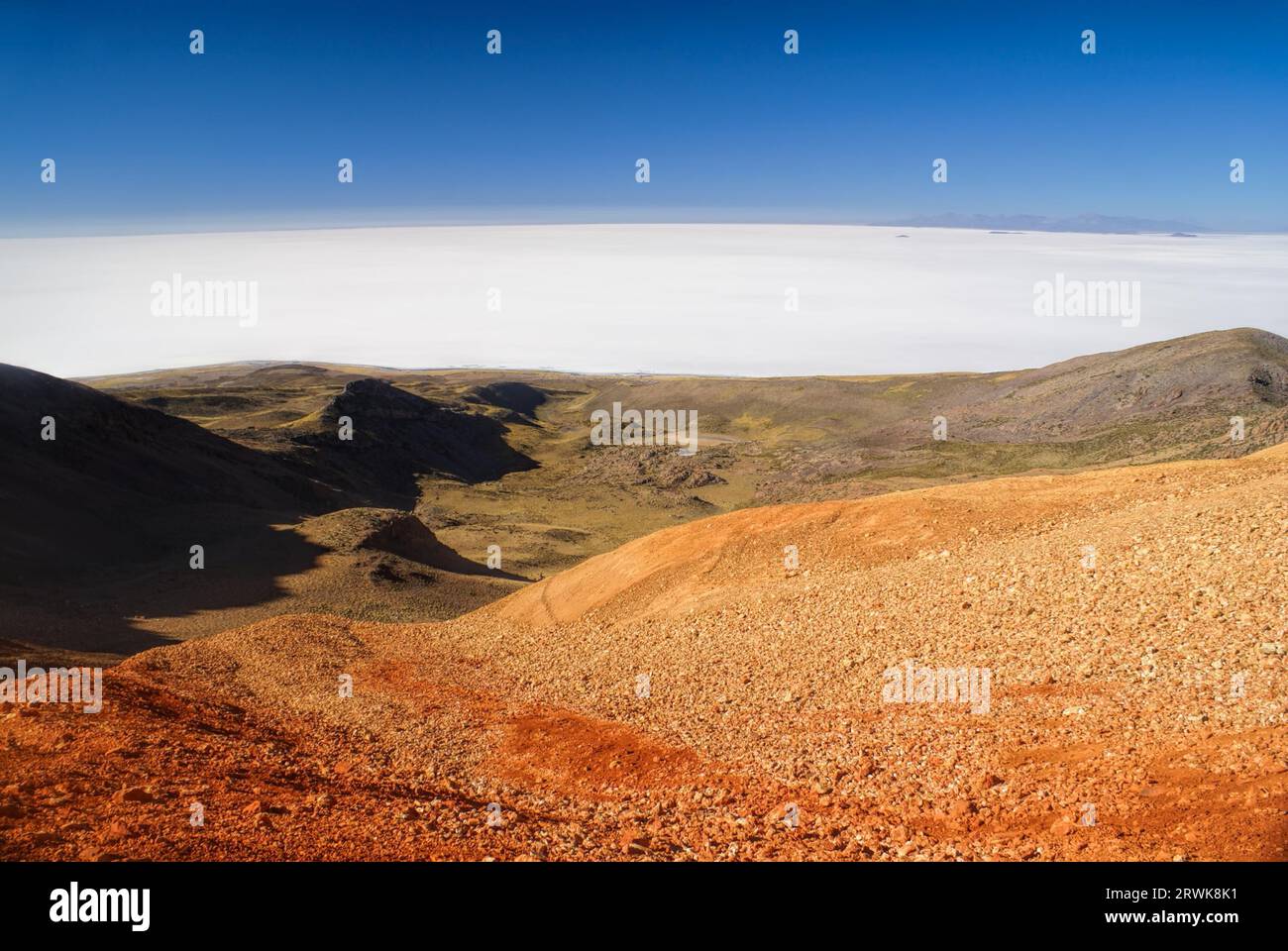 Scenic view of vast white salt plane Salar de Uyuni from colored mountains Stock Photo