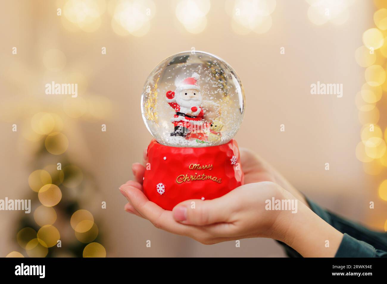 Woman holding up crystal ball hi-res stock photography and images - Alamy