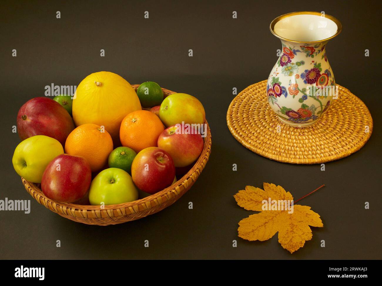 Fruit Bowl with Vase and Maple Leaf Stock Photo