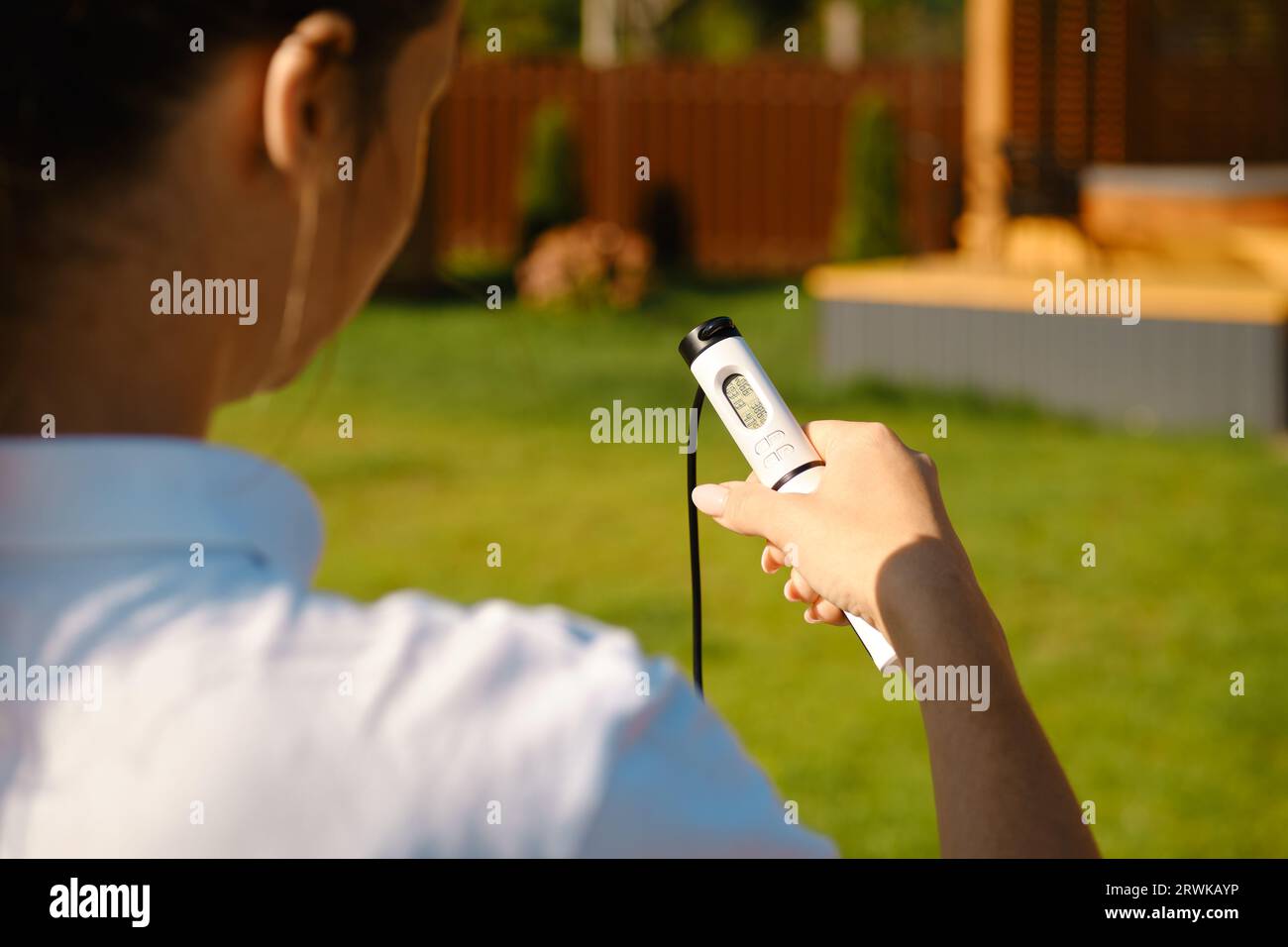 Mid adult a woman setting up smart digital rope outdoors Stock Photo ...