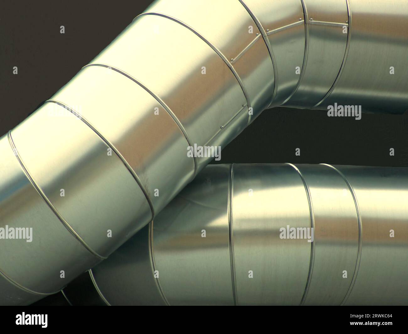 Large exhaust pipes, slightly alienated, background dark brown Stock Photo