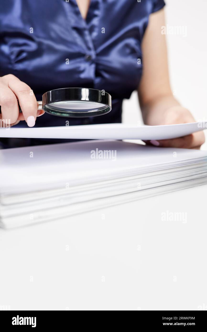 Magnifying glass examines financial documents hi-res stock photography ...