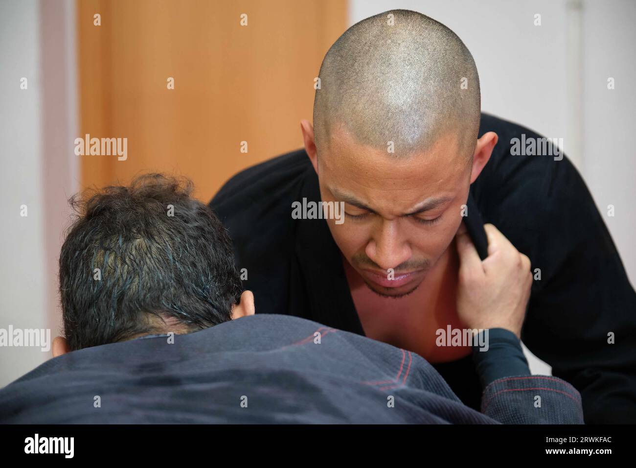 Two men practicing Brazilian Jiu-Jitsu sparring at the Academy. BJJ training. Stock Photo