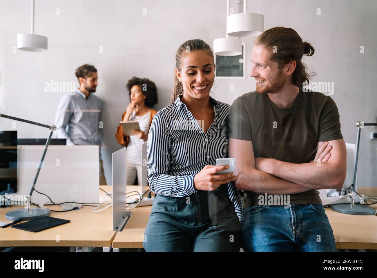 Portrait of creative business team working, smiling together at startup company. Stock Photo