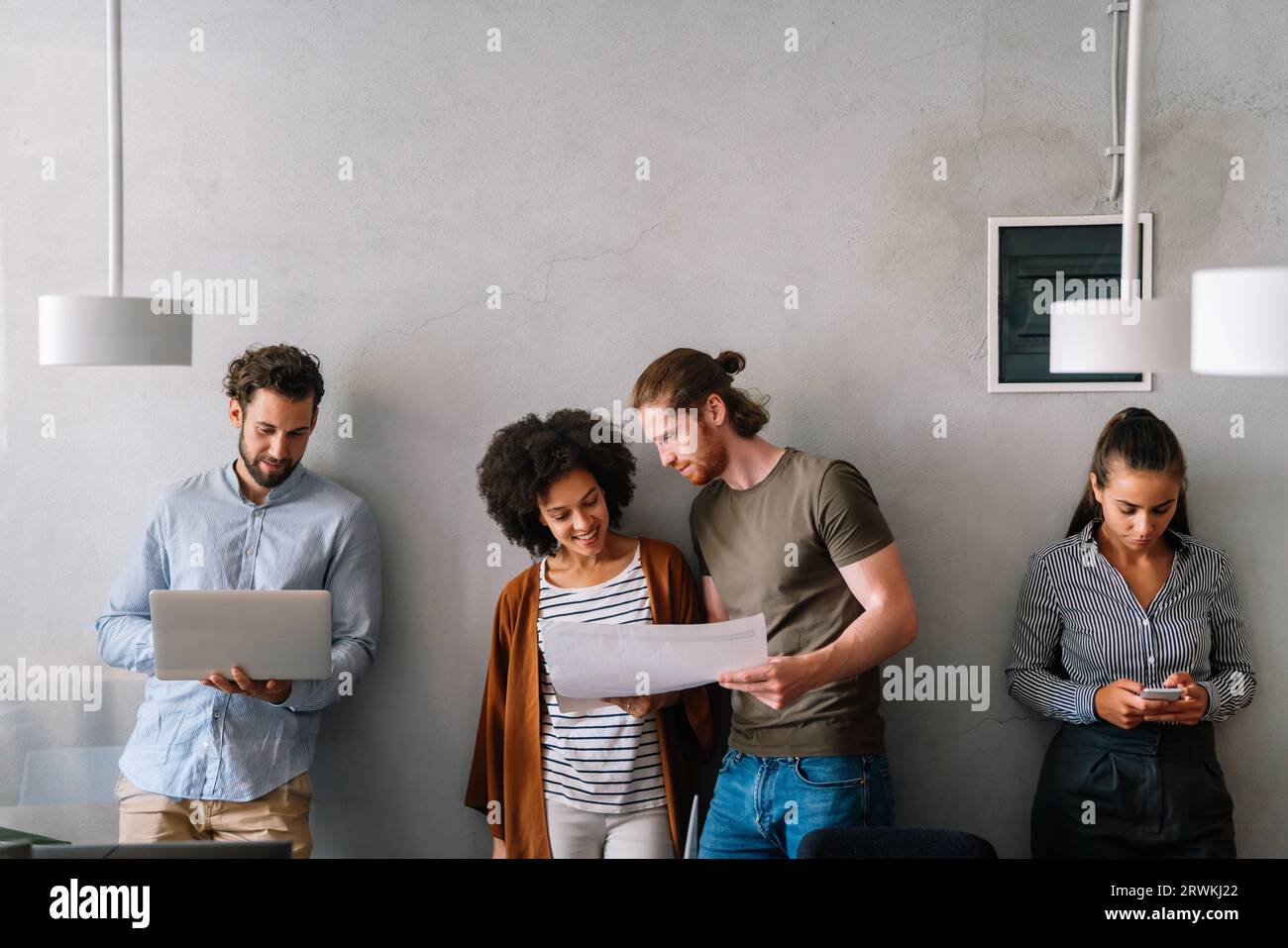Group of young happy creative team, multicultural coworkers working in office together Stock Photo
