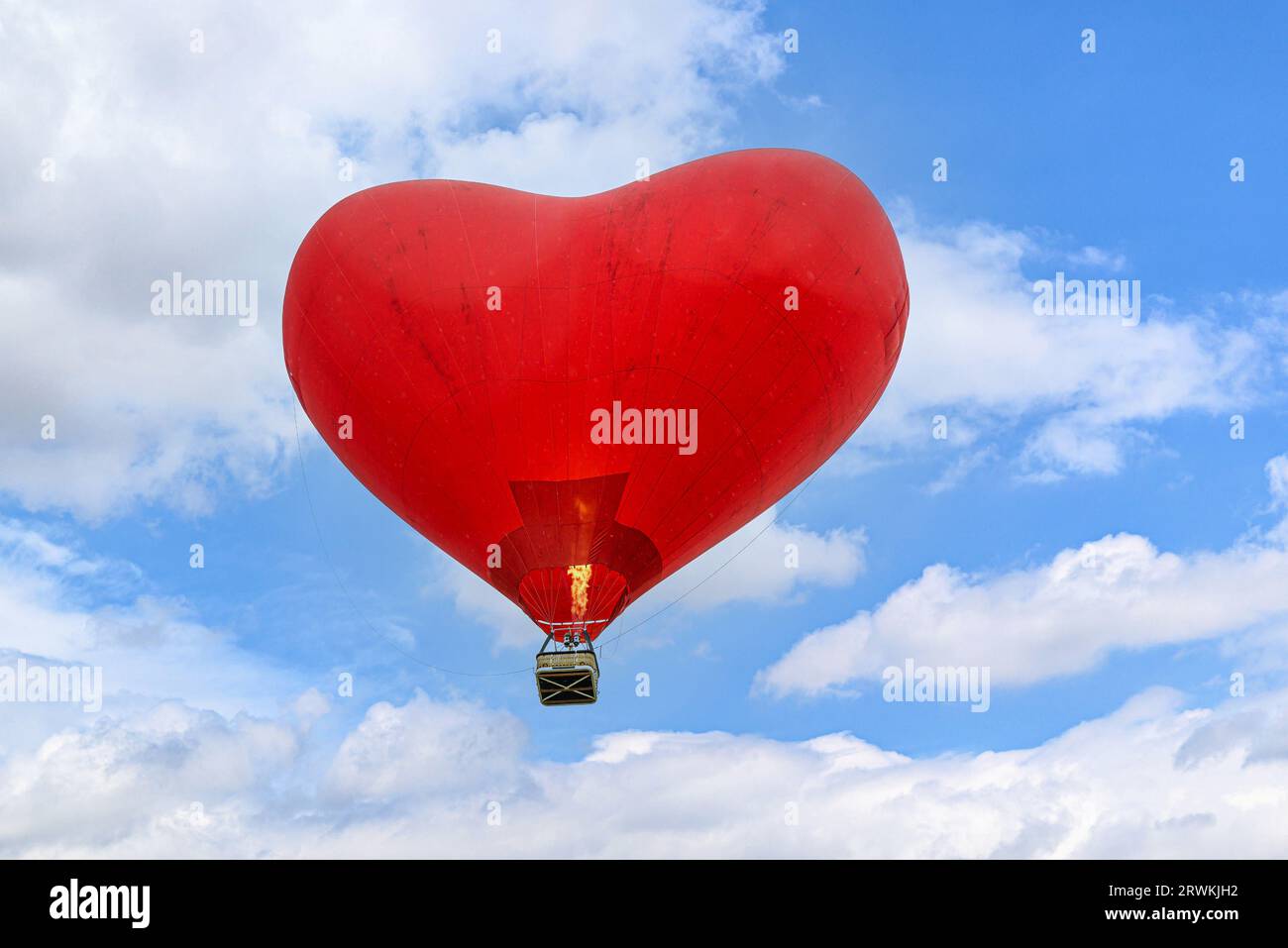 Colorful hot air balloon flying over blue sky with white clouds Stock ...