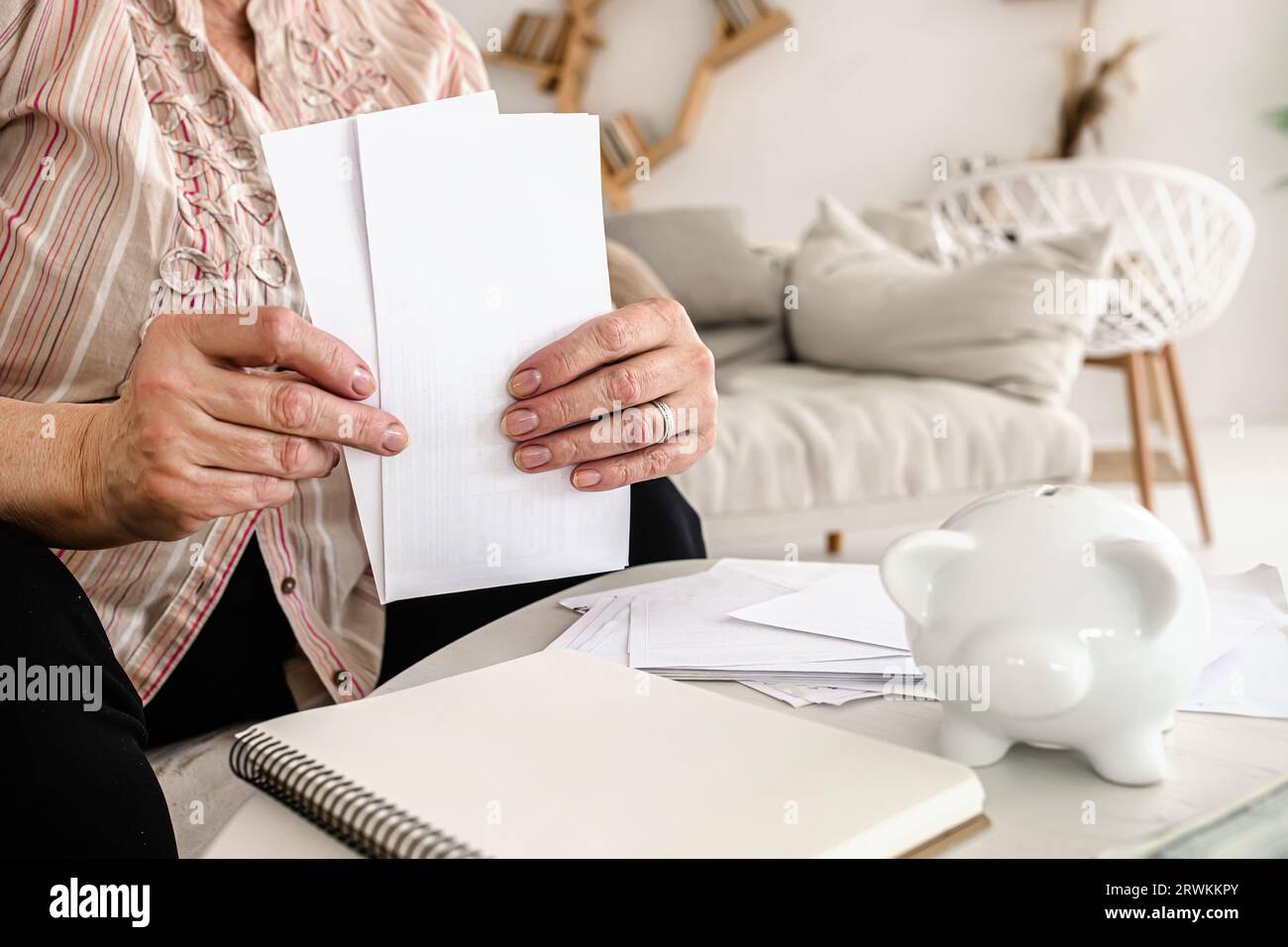 Ukrainian senior citizen concerned about electricity expenses. Managing household finances Stock Photo