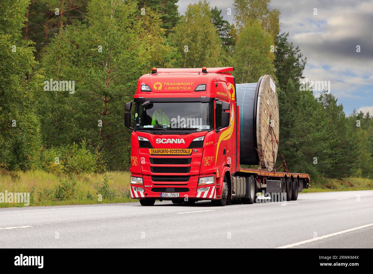 Red Scania 500S truck of Transport Logistica transports large Prysmian cable reel on flatbed trailer. Raasepori, Finland. September 8, 2023. Stock Photo