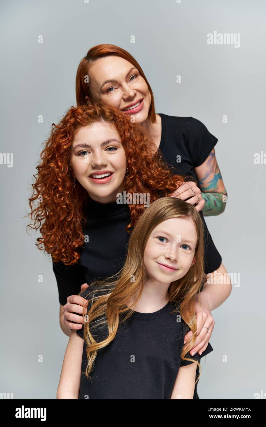 generations concept, cheerful family with red hair posing in matching ...