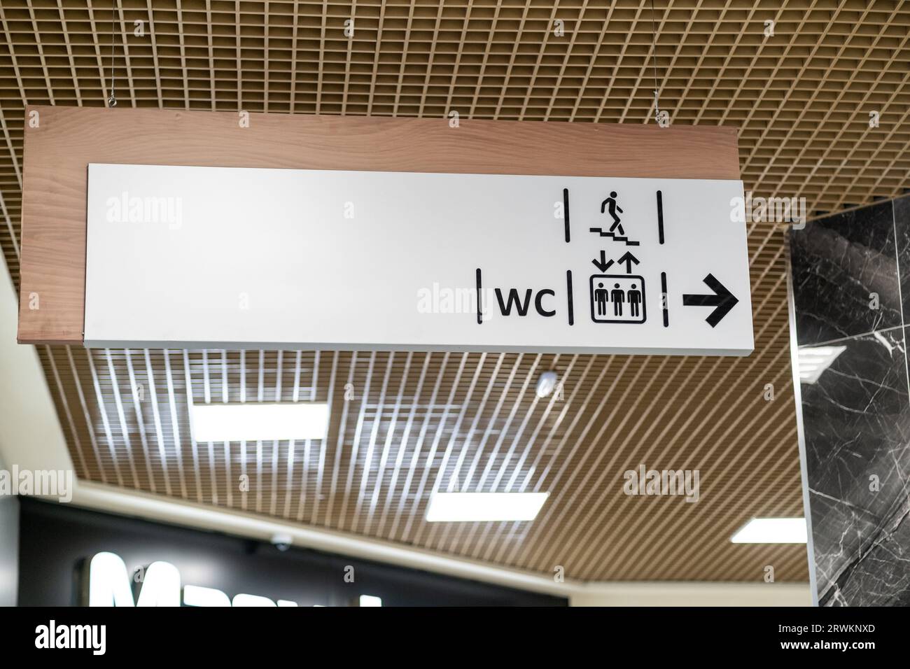 An information sign indicates directions to the toilet and stairs Stock Photo Alamy
