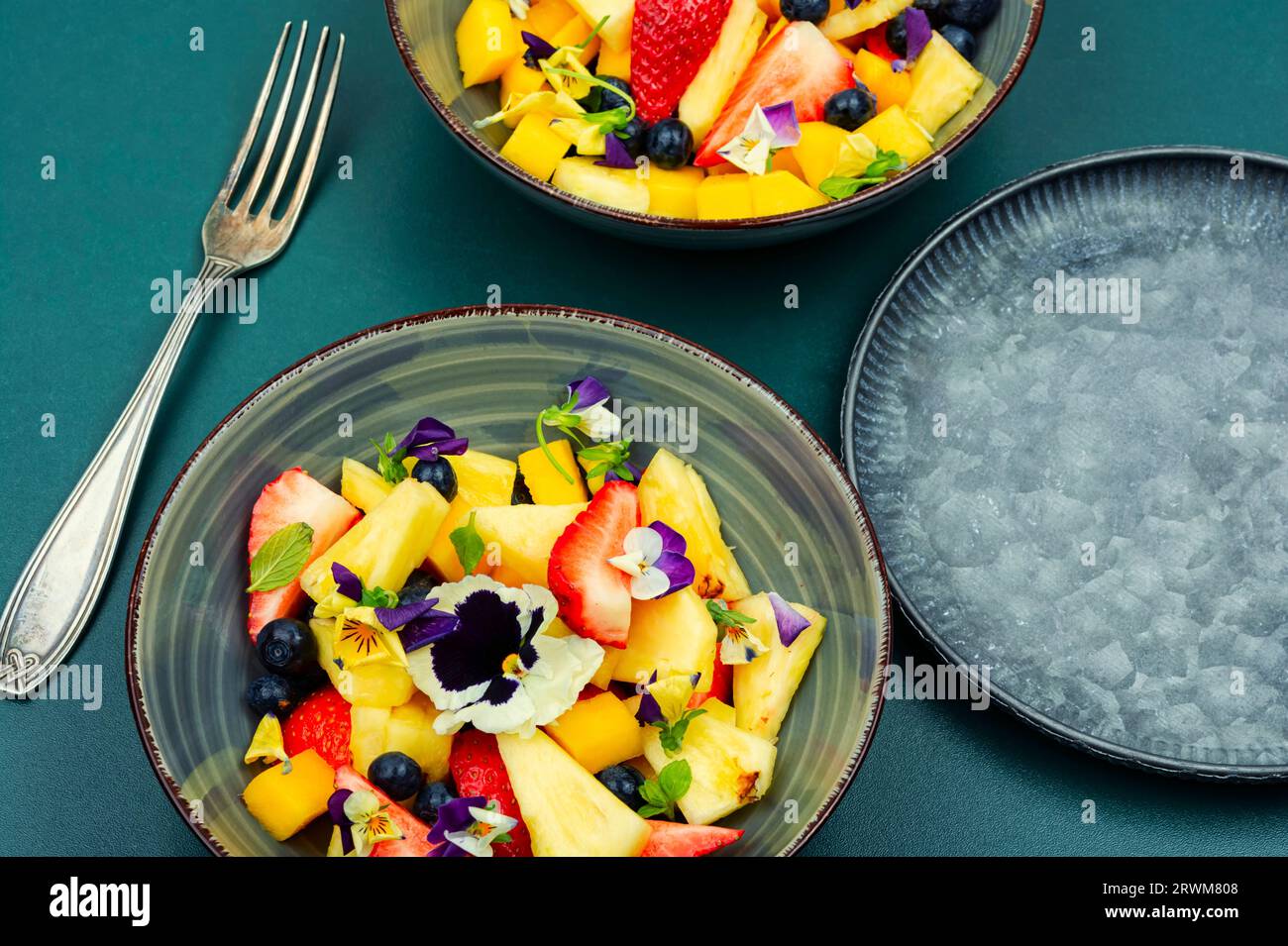 Delicious summer salad with field pansies and fruit Stock Photo - Alamy