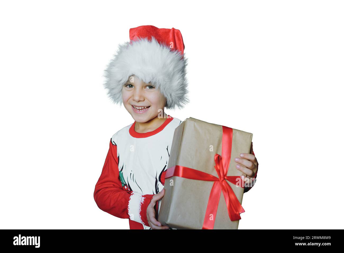 happy smiling caucasian boy in santa tee shirt and hat holding a box with christmas present. Child isolated on green background Stock Photo