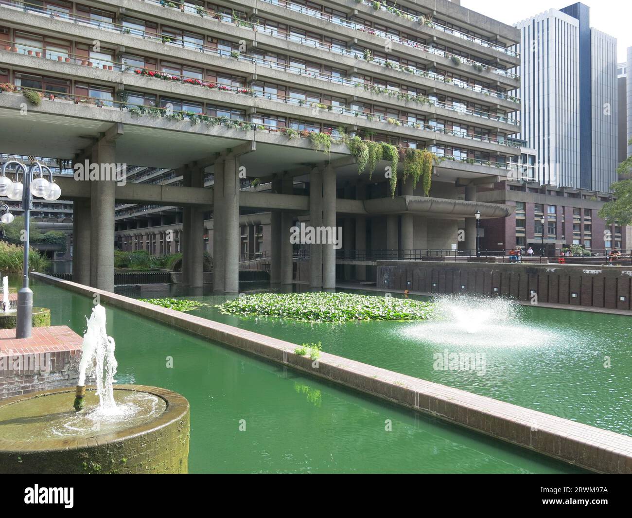 A large pond & water fountain soften the brutalist architecture of the ...