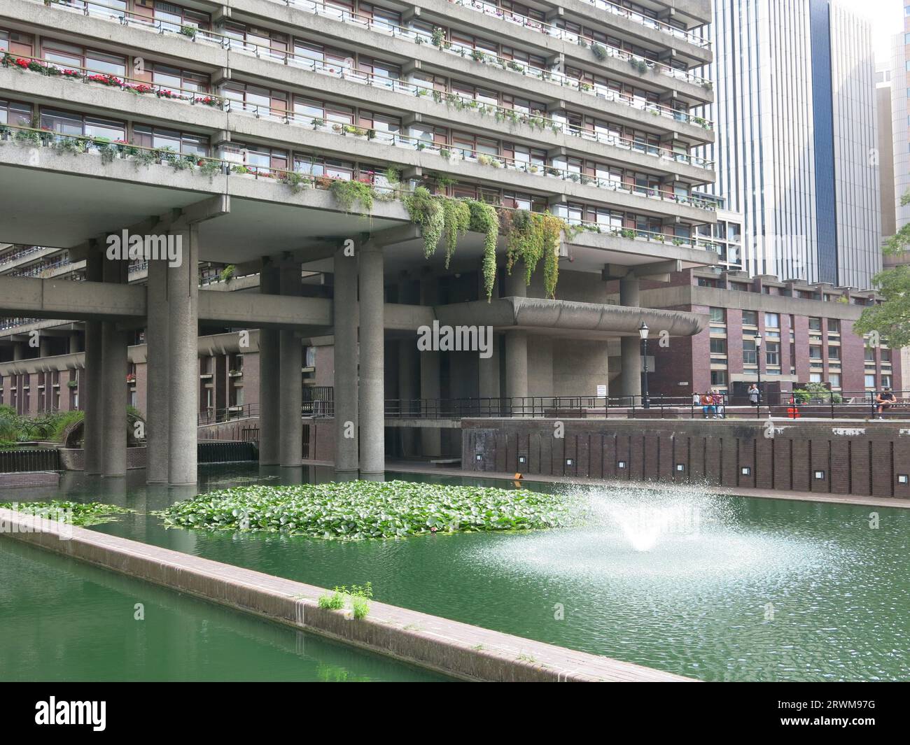 A large pond & water fountain soften the brutalist architecture of the ...