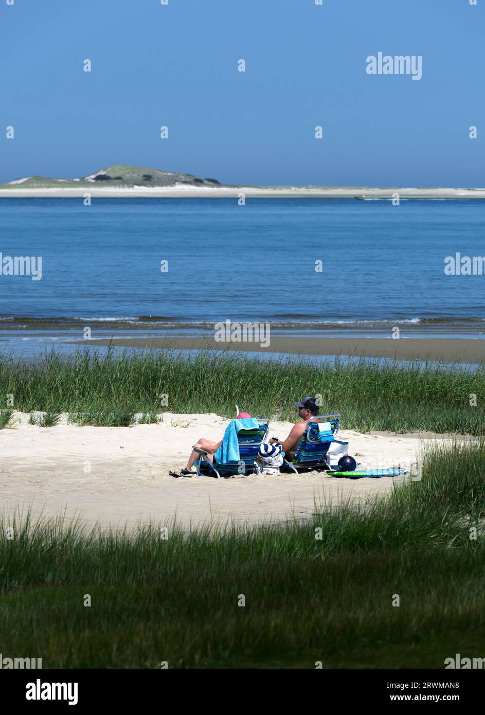 Senior couple sun bathing at Barnstable Harbor. Stock Photo