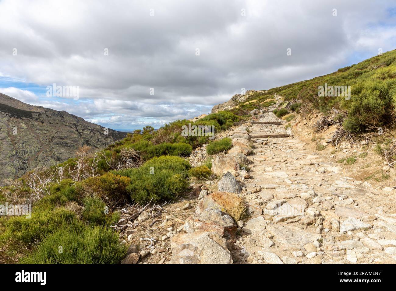 Stone hiking trail to the Laguna Grande de Gredos lake from the Plataforma de Gredos in Sierra de Gredos mountains, mountain pine trees, autumn, Spain Stock Photo