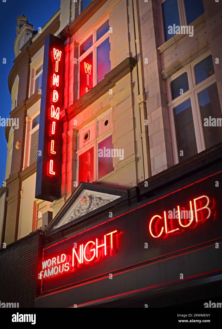 Red neon sign at dusk outside The Windmill, world famous night club, 17-19 Great Windmill St, London, England, UK, W1D 7JZ Stock Photo