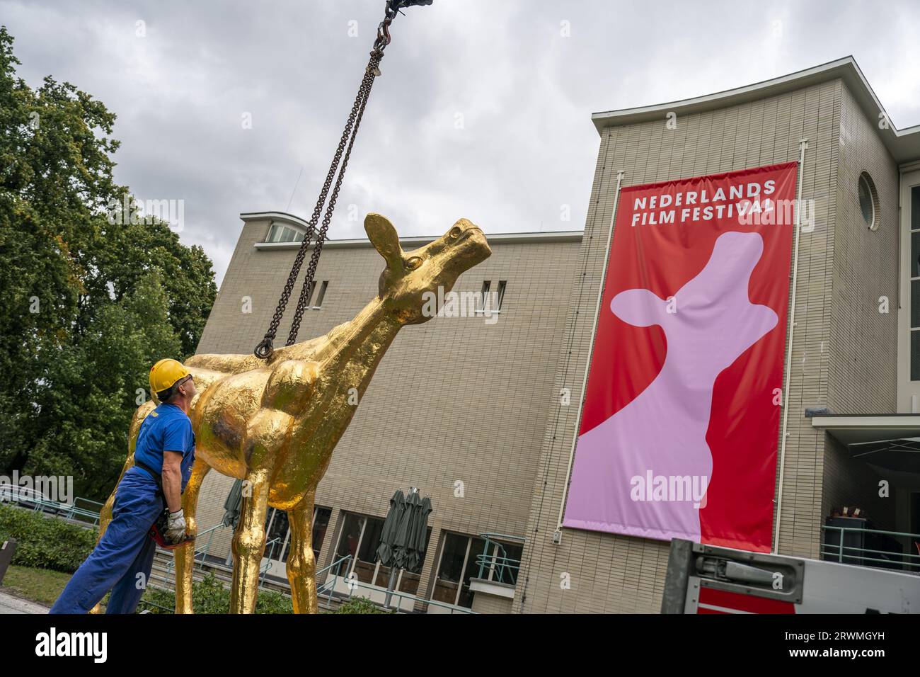 UTRECHT - The installation of the large Golden Calf statue, the icon of the Dutch Film Festival (NFF) at the Stadschouwburg Utrecht. Utrecht will be renamed the film capital of the Netherlands for a week and a half, where the latest feature films, documentaries, animations, short films, series and VR productions are presented. ANP JEROEN JUMELET netherlands out - belgium out Stock Photo