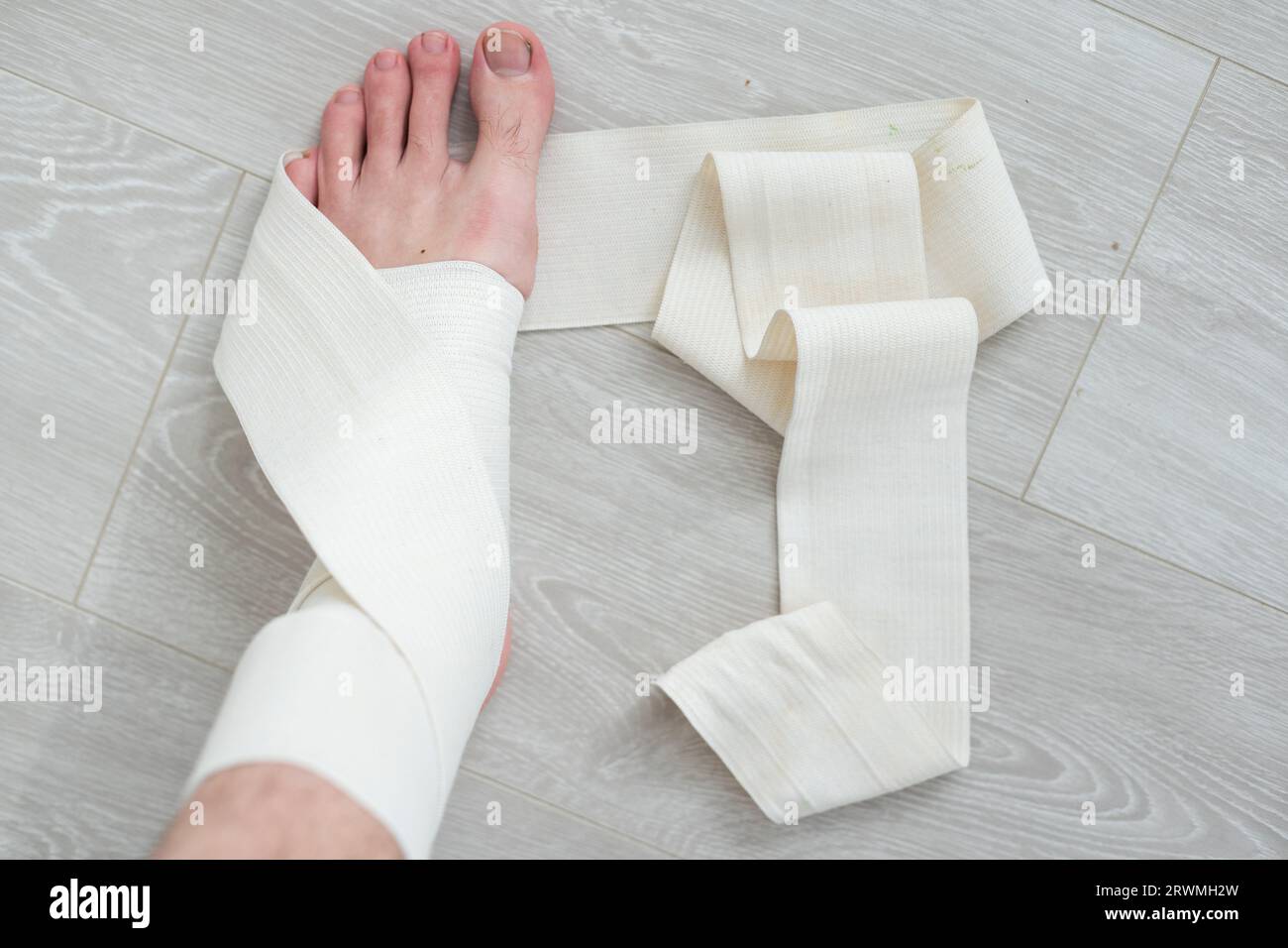 man using put on elastic bandage with legs having leg pain Stock Photo