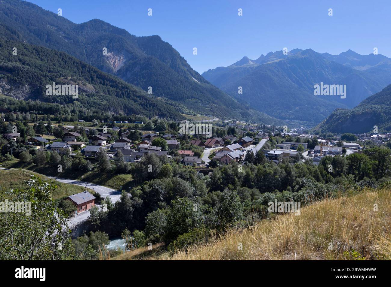 View looking towards Modane in the Maurienne Valley in the Auvergne-Rhône-Alpes region in southeastern France. Scenic mountain French landscape in the Stock Photo