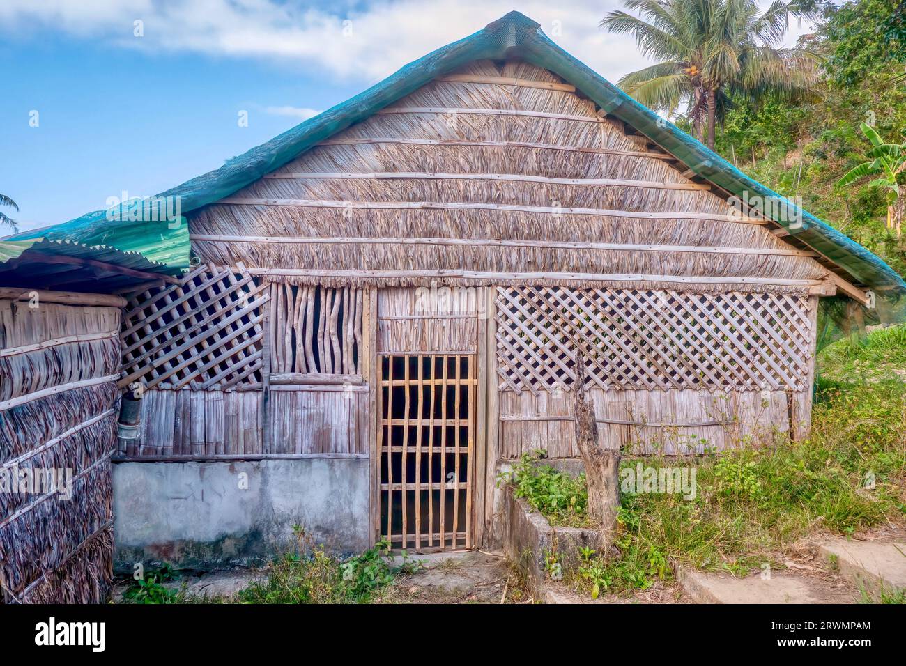 A traditional thatched house in the Philippines made almost entirely of native materials from bamboo and palm trees. Stock Photo