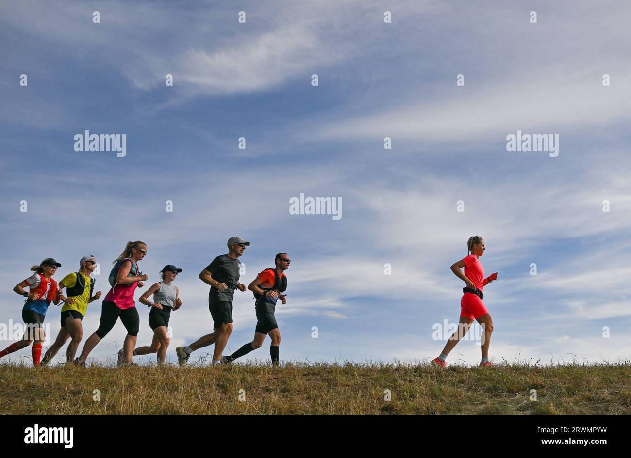 20 September 2023, Brandenburg, Reitwein: Joyce Hübner (r), athlete, is on her last leg of the Tour of Germany on the dyke along the German-Polish border river Oder towards Frankfurt (Oder). Joyce Hübner is accompanied by other runners. The finish is planned for the afternoon at the city bridge in Frankfurt (Oder). Joyce Hübner has now run 120 marathons in a row, covering a distance of 5,200 kilometers along the German border. With this project, the extreme athlete wants to inspire other people to leave their comfort zone and show how testing your personal limits can have a lasting positive ef Stock Photo