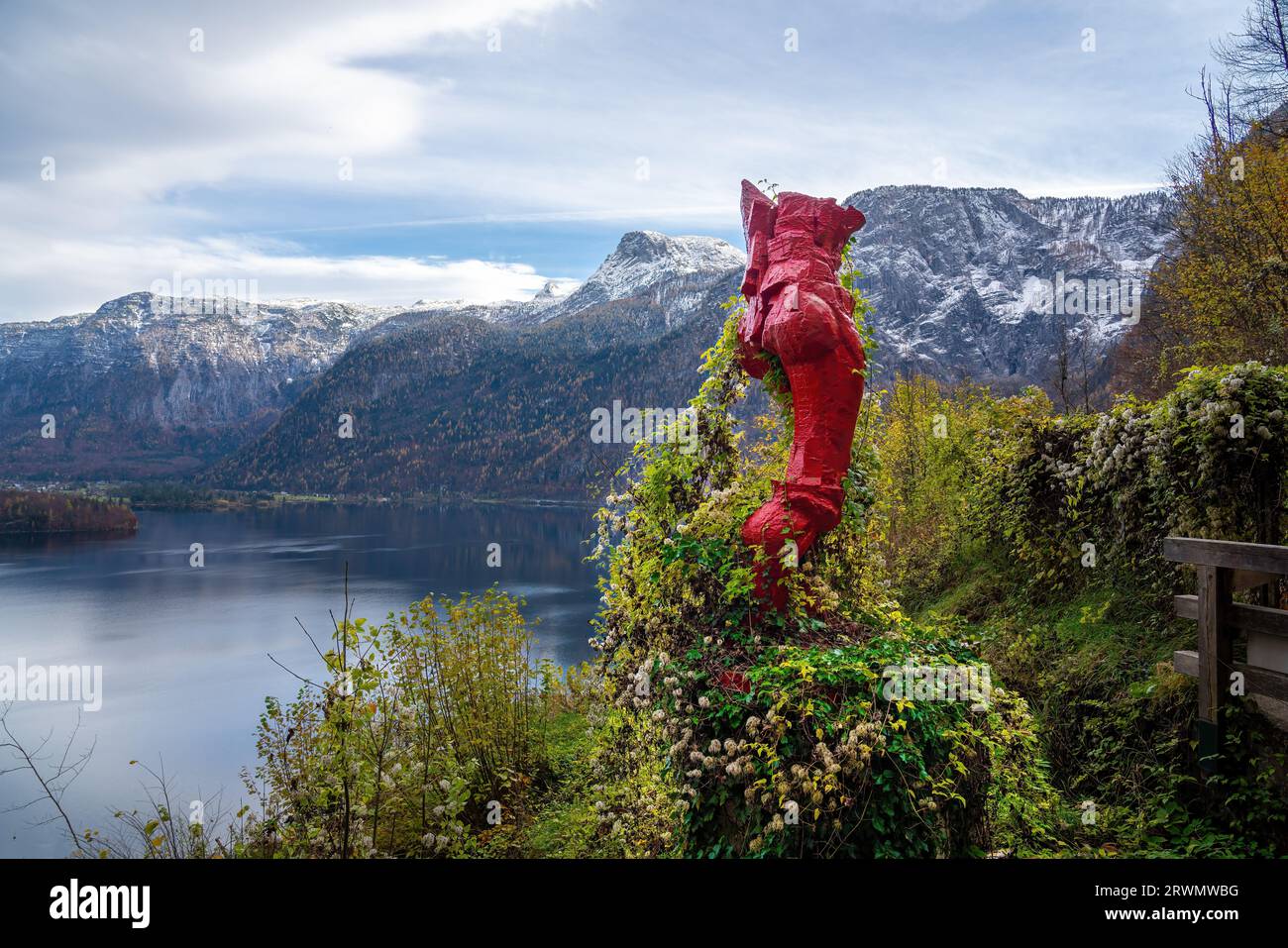 Red Sculpture on the Panorama Trail with view of Lake Hallstatt and Alps Mountains - Hallstatt, Austria Stock Photo