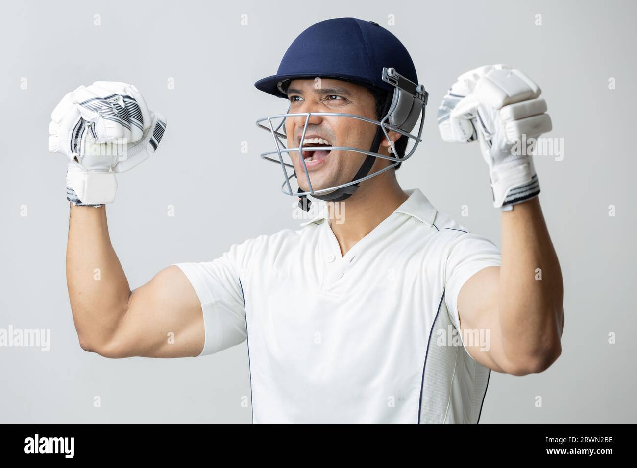 Man In cricket dress with helmet screaming in joy and anger, Cricketer