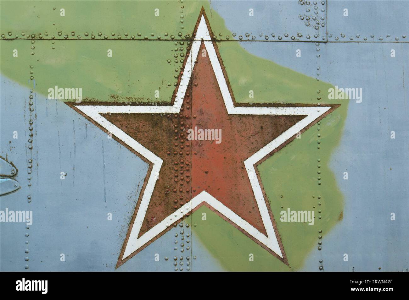 A star on the fuselage of an old military helicopter. The symbol of the Soviet Union is a red star. Stock Photo