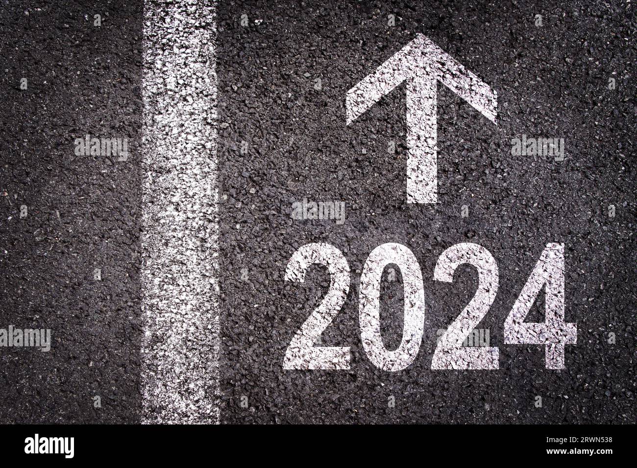 Direction 2024 written on asphalt road background, new year business goal illustration Stock Photo