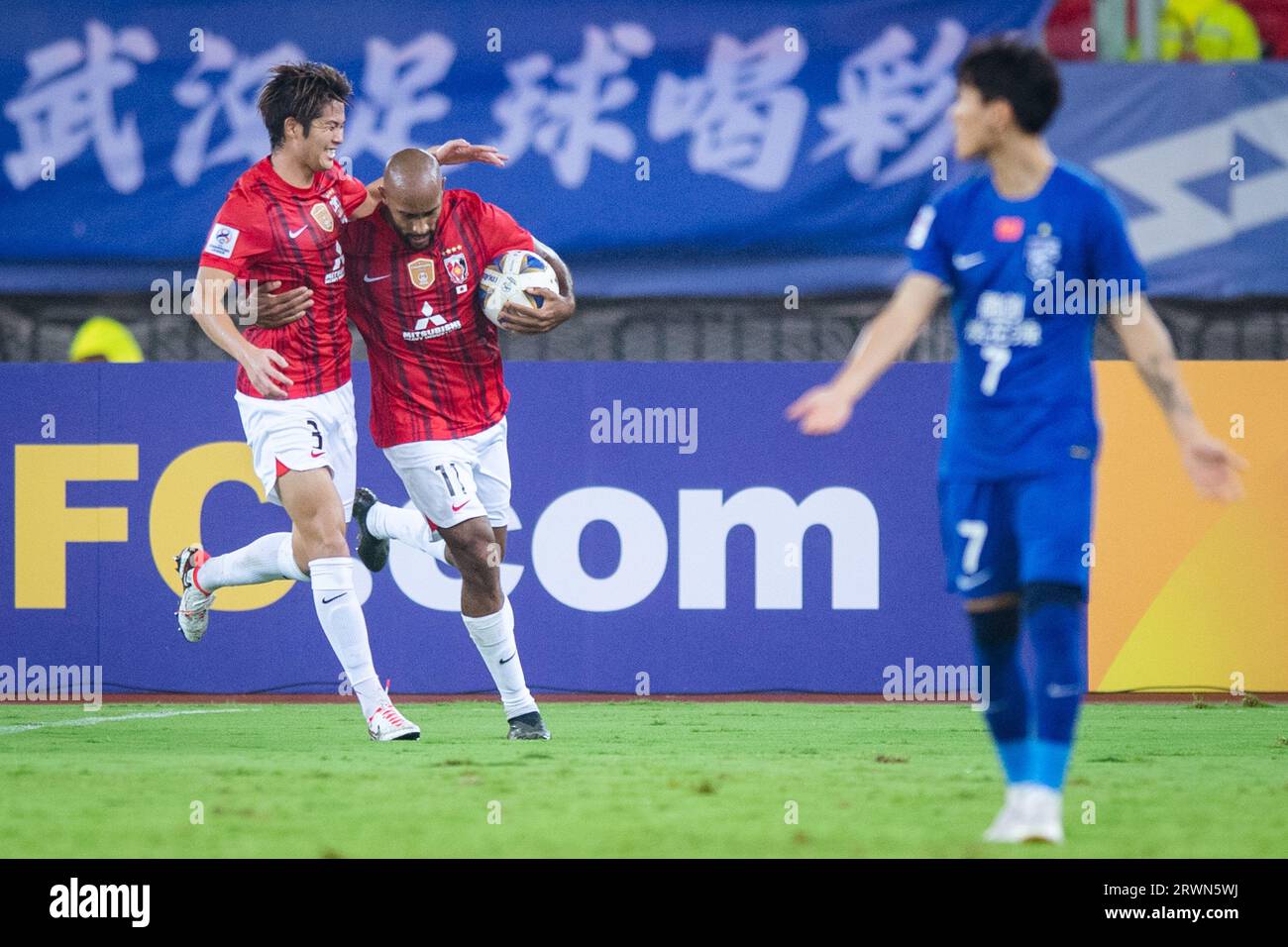 Al Hilal's Ali Al Bulayhi, right, fights for the ball with Urawa