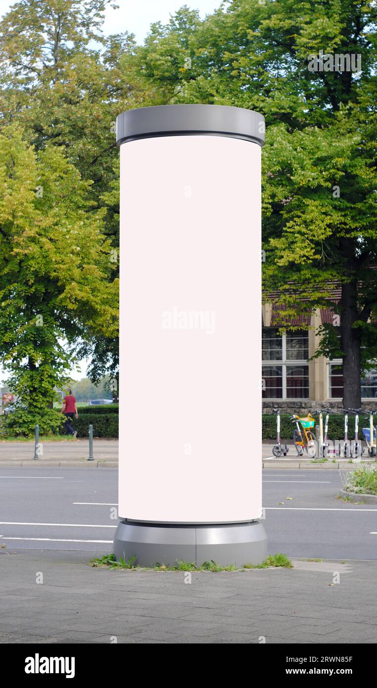 Empty advertising pillar in a city with white  free copy space, promotion mock up. Blank advertising panel Stock Photo